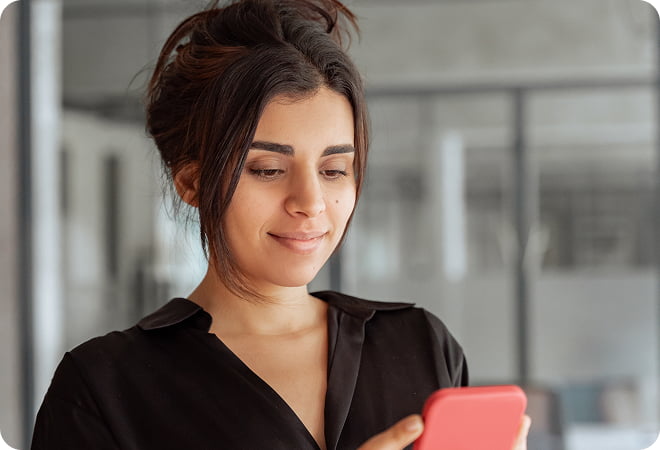 A woman smiling at phone